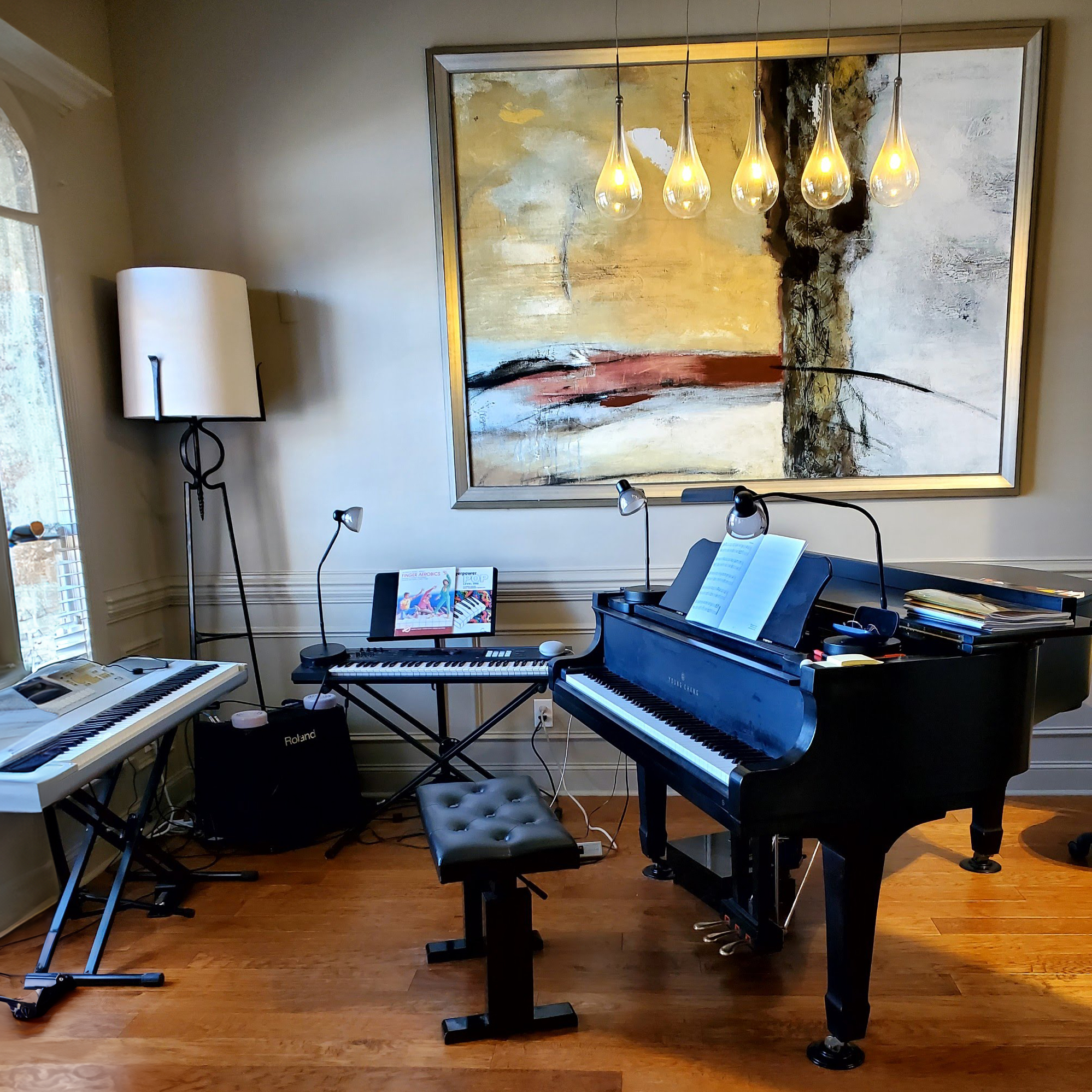 Inside Fullerton Music Studio with baby grand piano and guitars in Madison Alabama